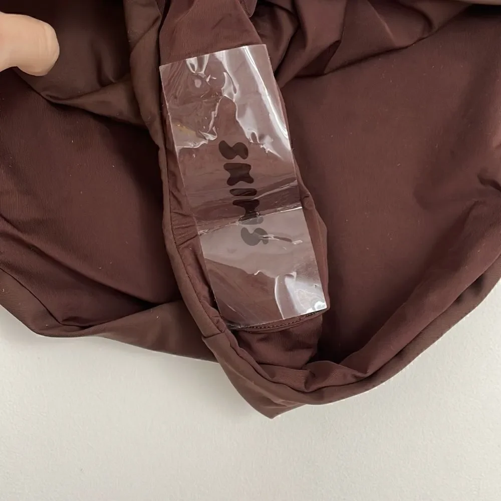 SKIMS SWIM BIKINI bottoms in chocolate brown